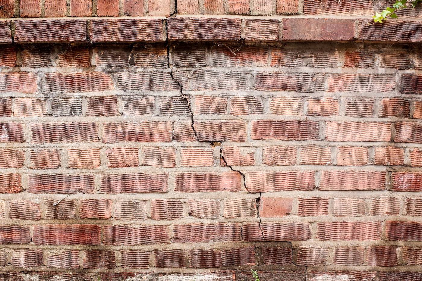A stair-step crack running through a brick wall, a classic sign of foundation movement on Central Texas clay.
